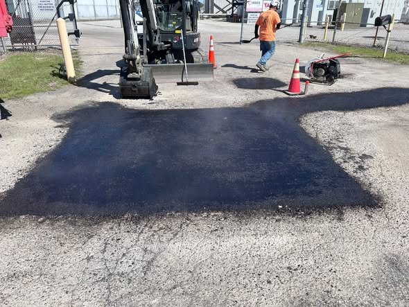 Fresh asphalt patch laid at the same power station entrance
